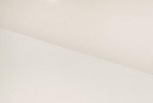 an empty room with wood flooring and a window