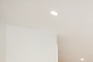 a renovated living room with a wooden floor and white walls