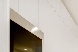 a kitchen with white cabinets and a wood floor