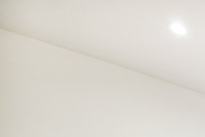 a living room with a hardwood floor and white walls