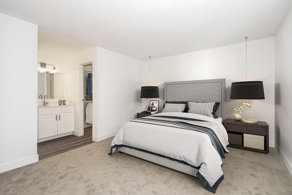 a bedroom with a bed and a bathroom