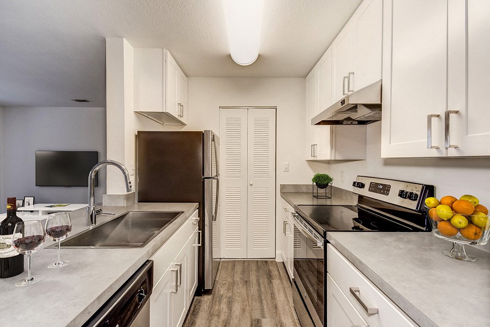 a kitchen with stainless steel appliances and white cabinets