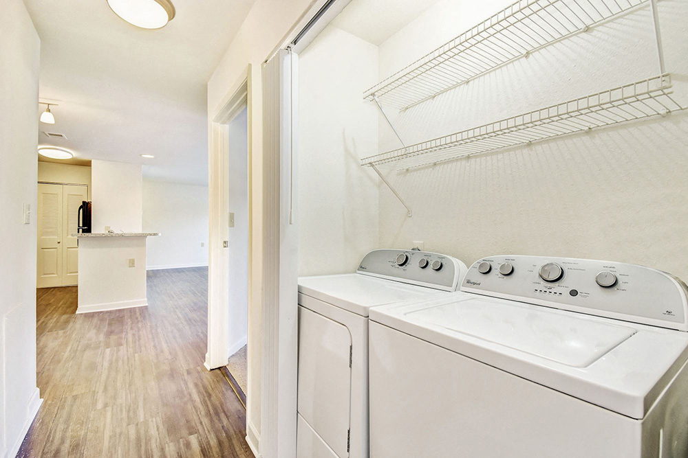 a washer and dryer in a laundry room with a kitchen