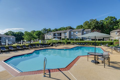 our apartments have a resort style pool with chairs and tables