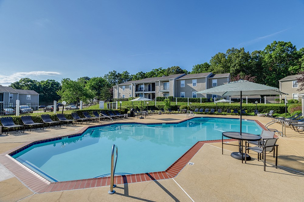 our apartments have a resort style pool with chairs and tables