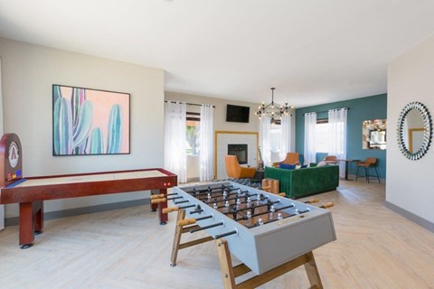 A room with a pool table and a couch.