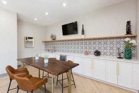 A dining room with a wooden table and chairs.