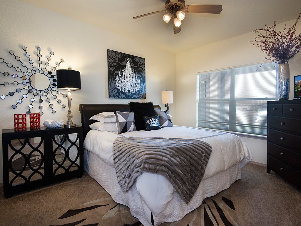 a bedroom with a large bed and a ceiling fan