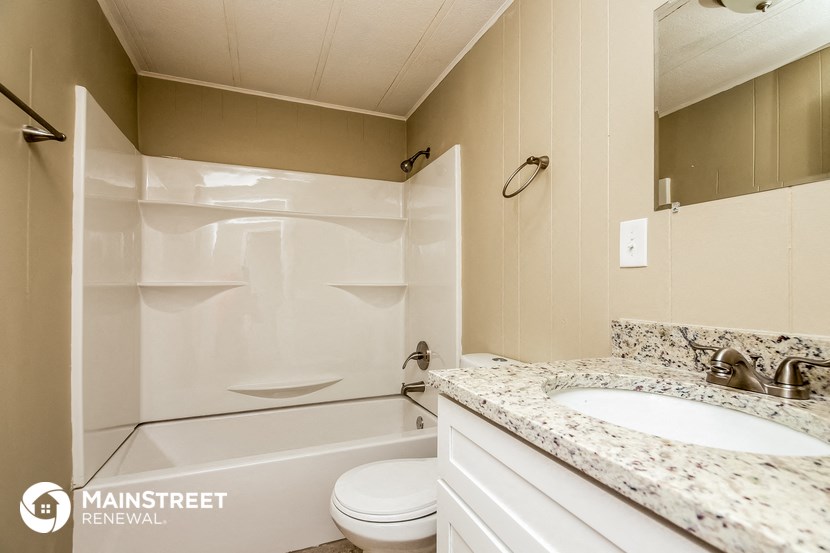 a bathroom with a sink and a toilet and a bath tub