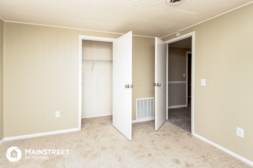 a master bedroom with two closets and three doors