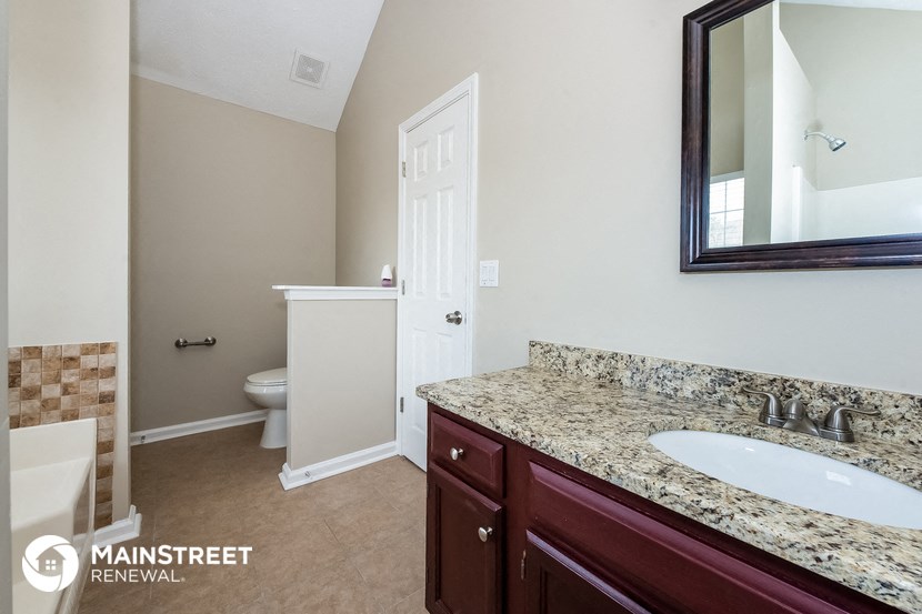 a bathroom with a sink and a toilet and a mirror