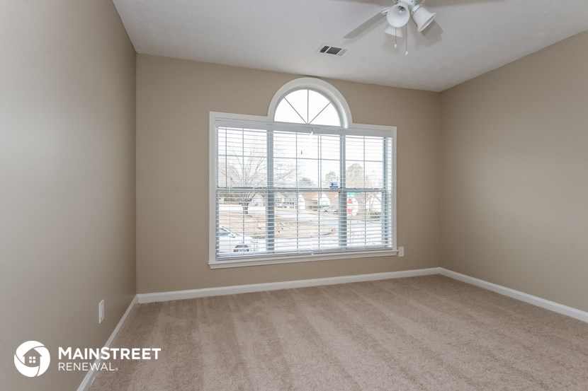an empty living room with a large window