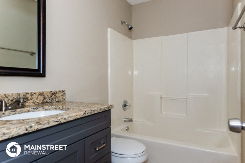 a bathroom with a shower and a sink and a toilet