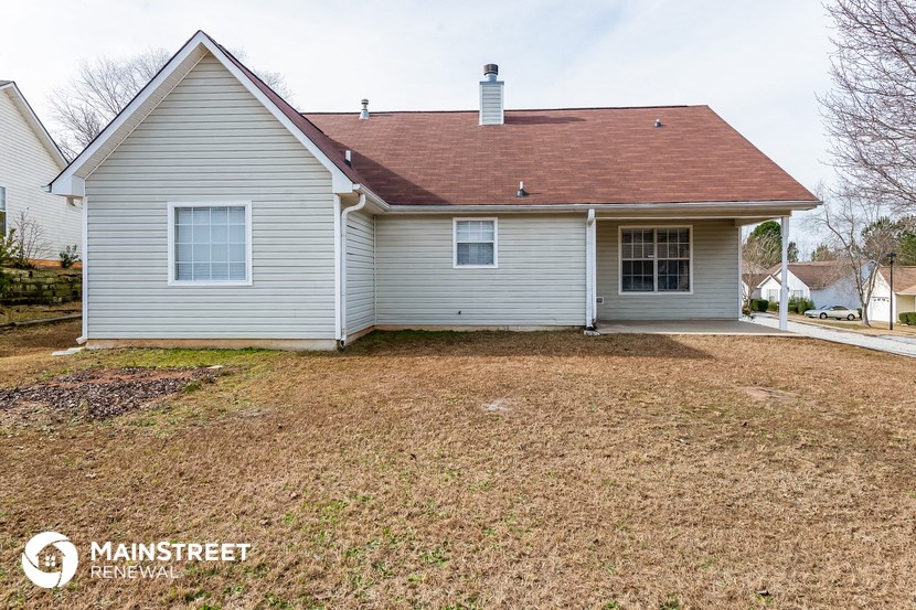 a white house with a yard in front of it