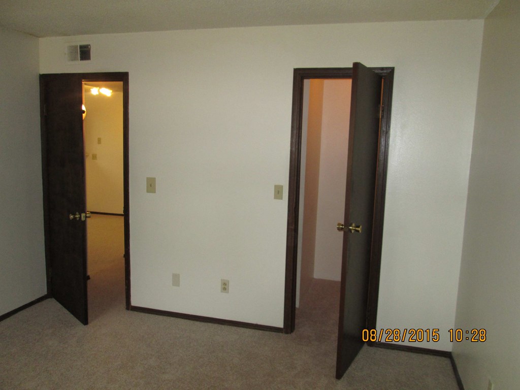 the living room and closet of a small apartment