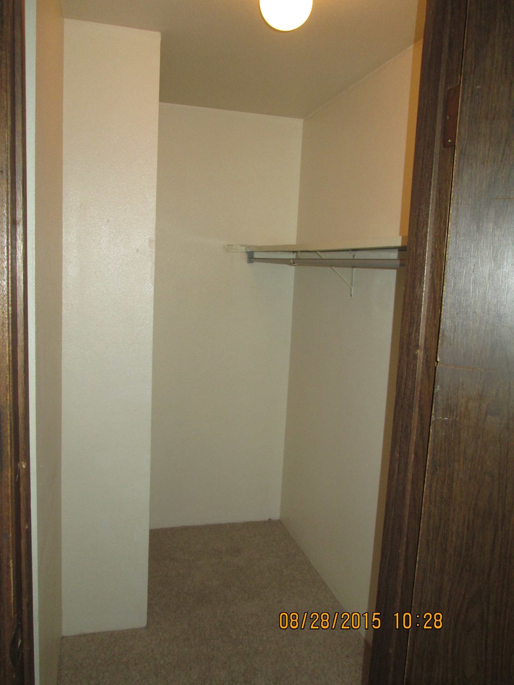 an empty closet in a room with a white wall