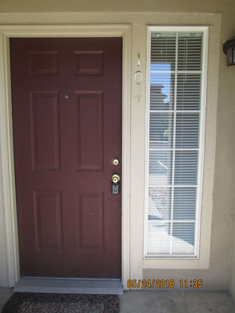 the front door of a house with a red door