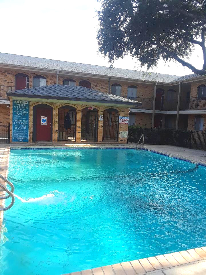 a large swimming pool in front of a building