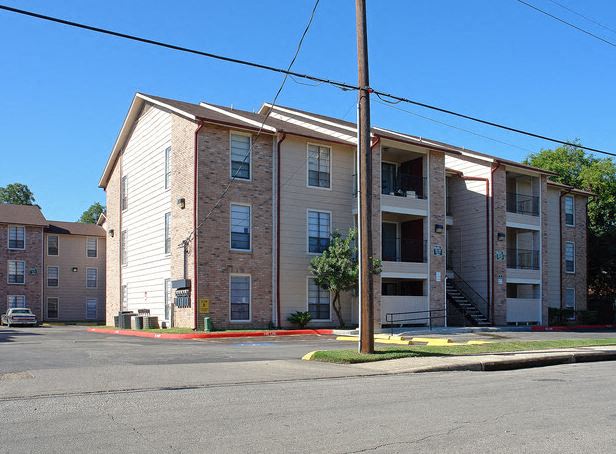 an apartment building on the corner of a street