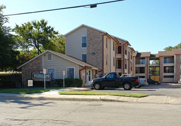 a truck parked in front of an apartment building