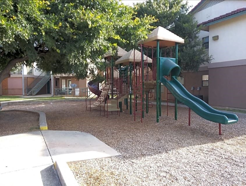 a playground with a slide and other playground equipment