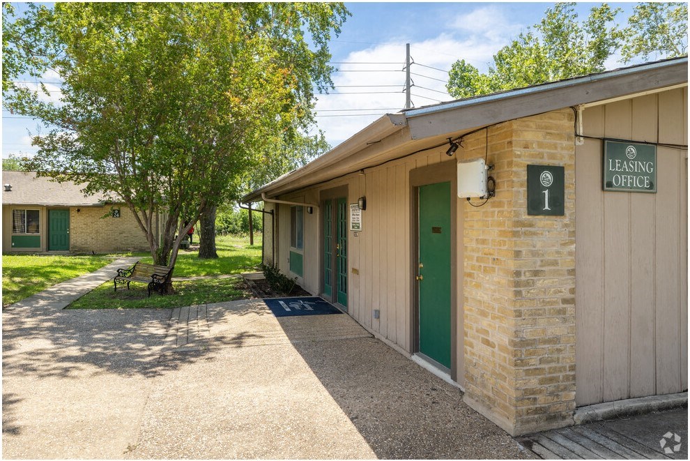 a side view of a building with a green door
