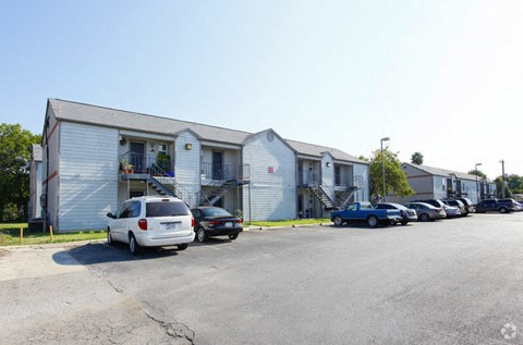 a parking lot with cars in front of a building