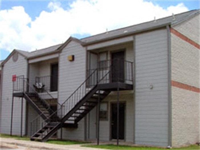 a white building with stairs on the side of it