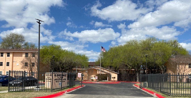 a house with a fence and an flag
