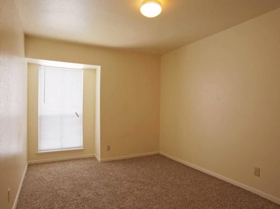 Bedroom view  with sandy colored carpets and eggshell white walls