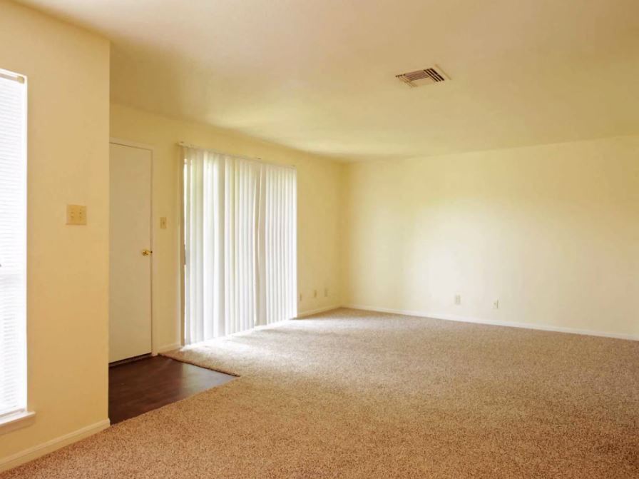 Living Room view with sandy colored carpets and eggshell white walls