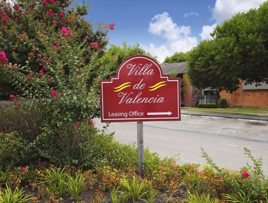 red and yellow community sign pointing to leasing office