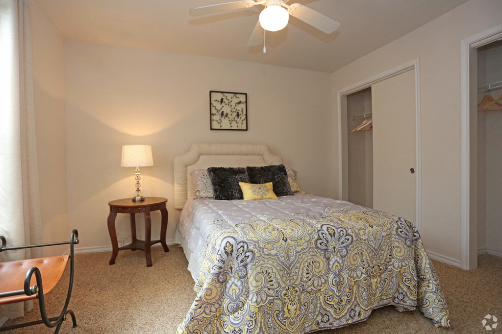 a bedroom with a bed and a ceiling fan