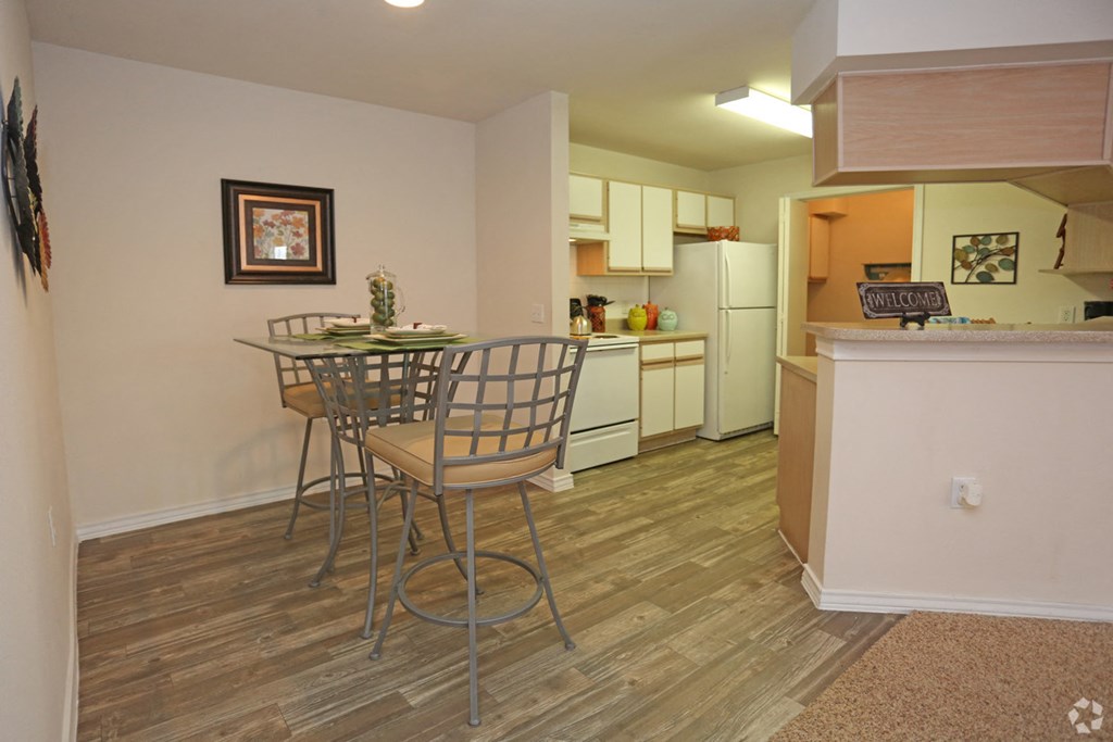 a kitchen and dining area with a table and chairs