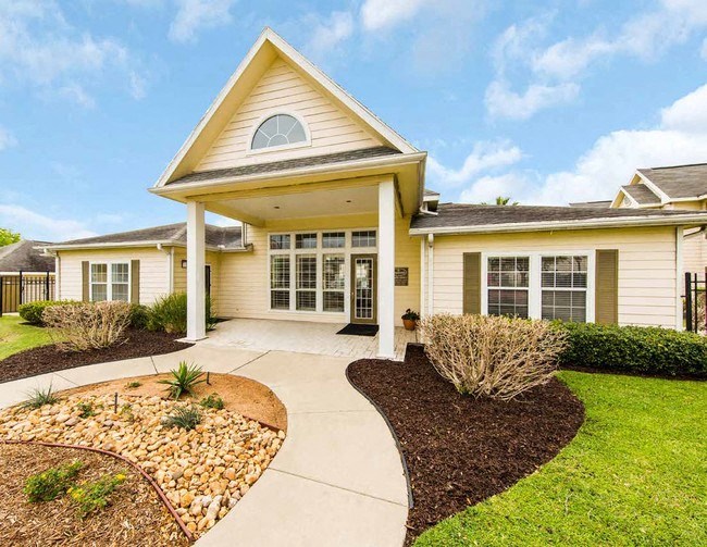 a yellow house with a sidewalk in front of it