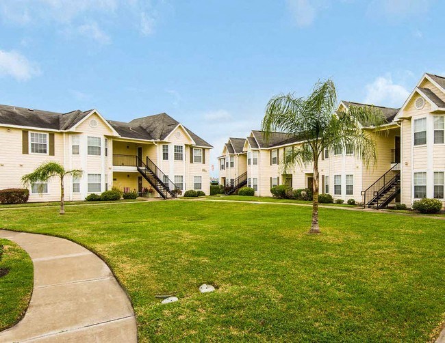 a row of houses on a green lawn