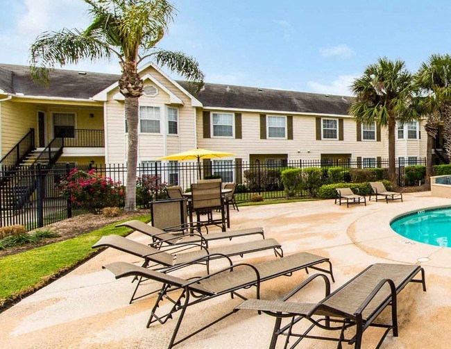a pool and tables in front of a building