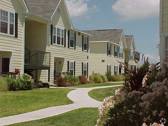a row of houses with a sidewalk