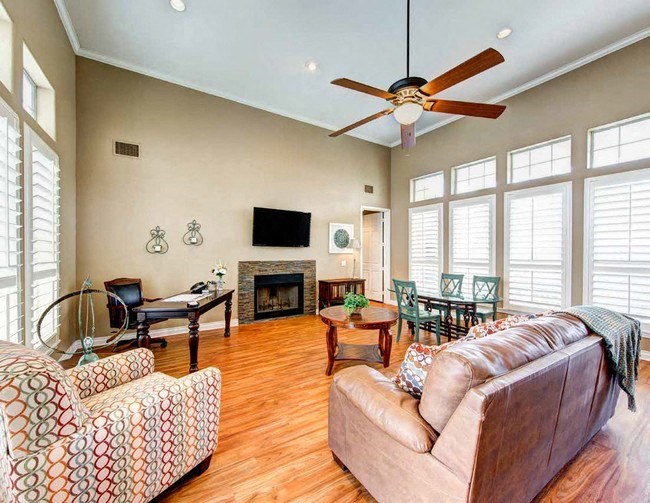 a living room with a couch and a ceiling fan