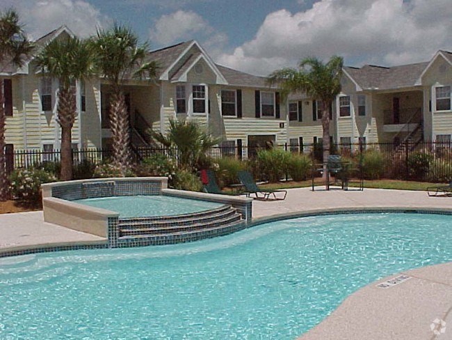 a large swimming pool with a building in the background