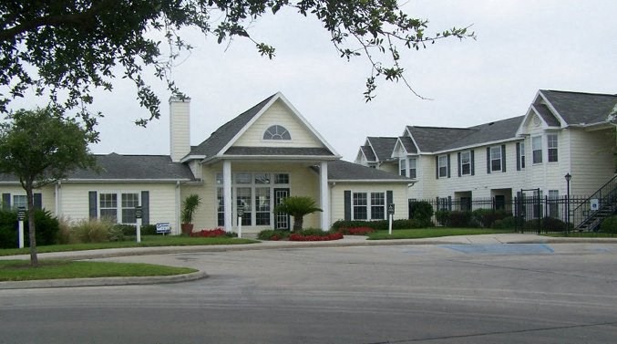 a large white house with a street in front of it