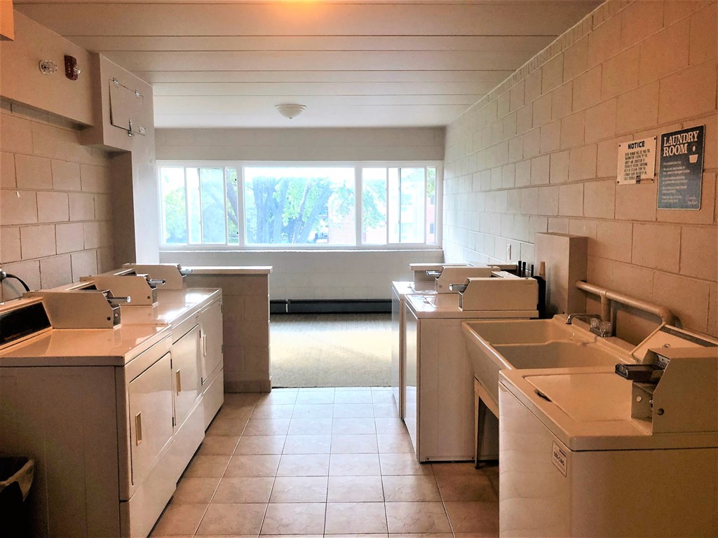 an empty kitchen with sinks and a window