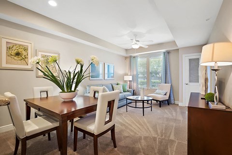 A dining room with a table and chairs.