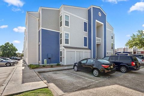 a blue and white building with cars parked in front of it