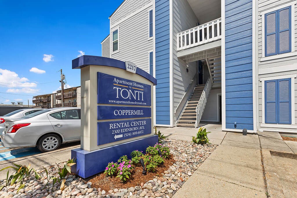 a building with a sign in front of a parking lot