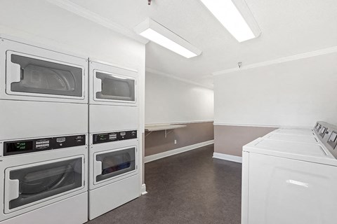 a white kitchen with white appliances and white counters
