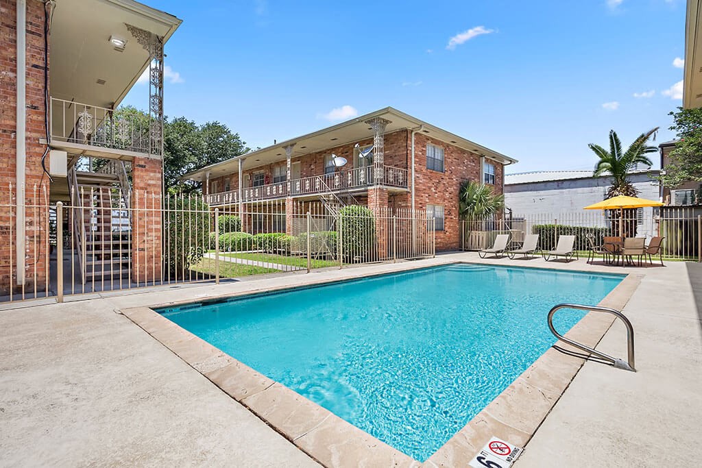 our apartments have a swimming pool and a patio with chairs