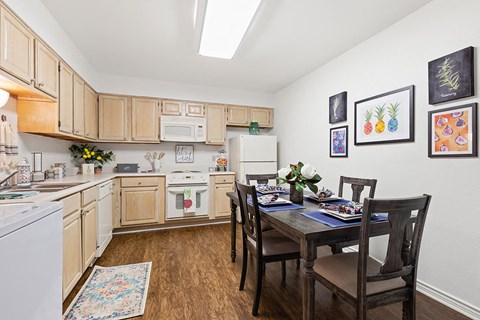 a kitchen and dining room with a table and chairs
