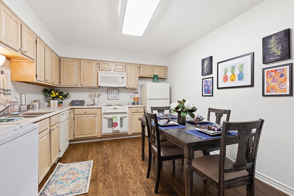 a kitchen and dining room with a table and chairs