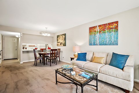 A living room with a white couch and a coffee table.